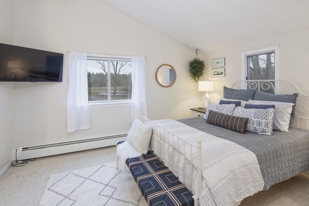 170 Haverhill Road Topsfield, MA 01983 - Photo 15 of 31 a bedroom with a bed and a flat screen tv
