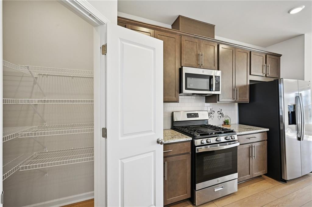216 Wilder Ridge Way Lawrenceville, GA 30044 - Photo 12 of 46 a kitchen with stainless steel appliances and cabinets