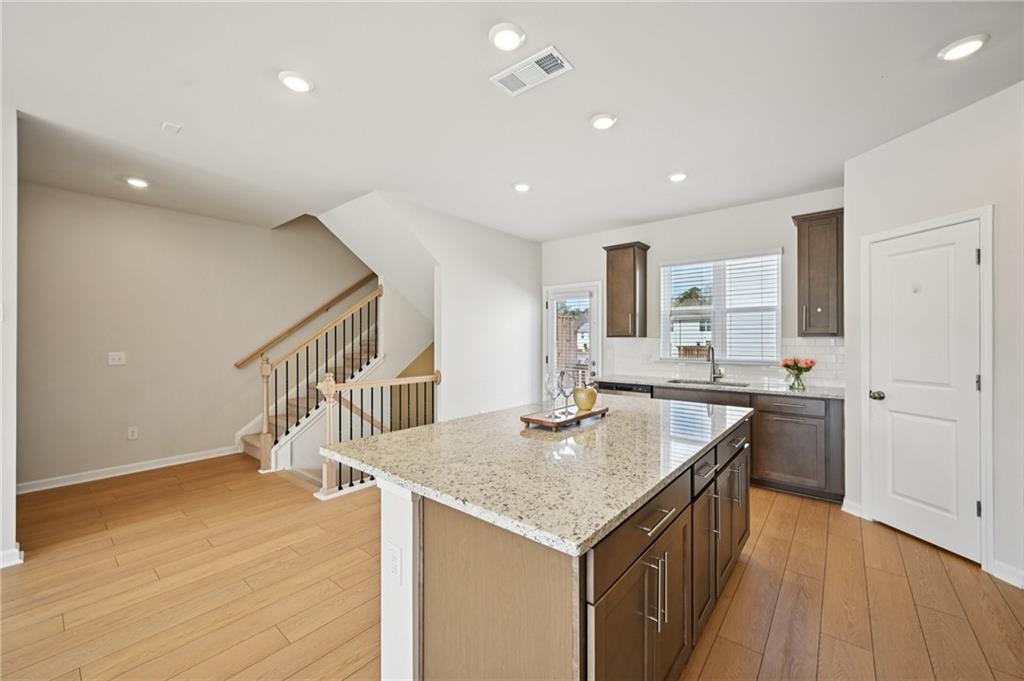 216 Wilder Ridge Way Lawrenceville, GA 30044 - Photo 13 of 46 a kitchen with sink cabinets and wooden floor