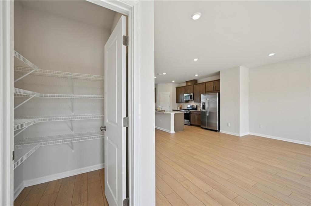 216 Wilder Ridge Way Lawrenceville, GA 30044 - Photo 14 of 46 a view of a kitchen with wooden floor and a kitchen