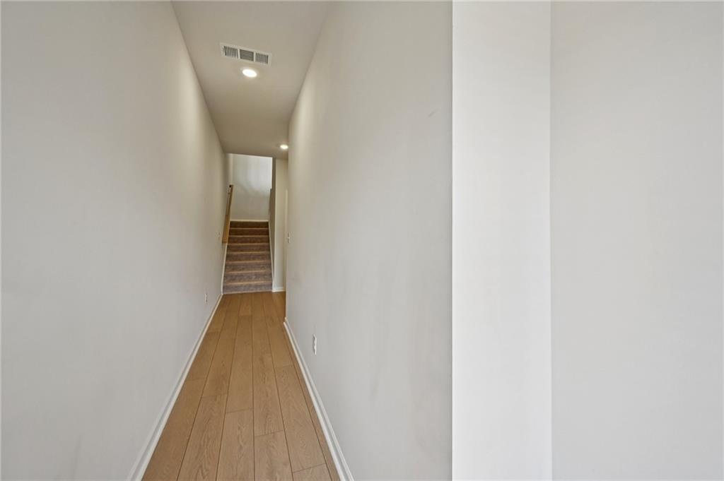 216 Wilder Ridge Way Lawrenceville, GA 30044 - Photo 15 of 46 a view of a hallway with wooden floor and entryway