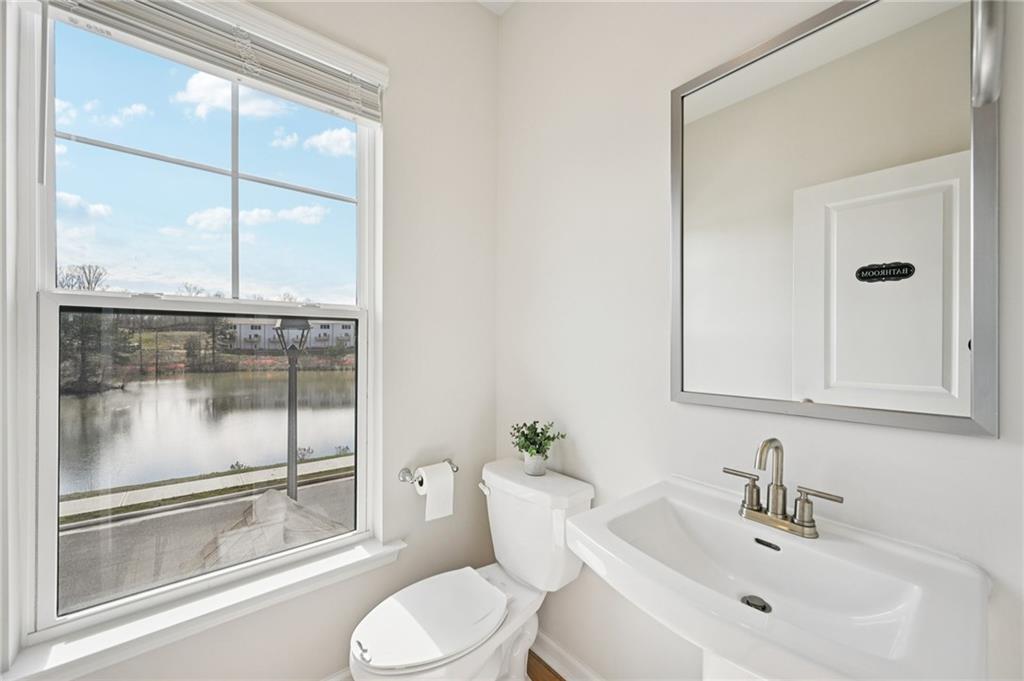 216 Wilder Ridge Way Lawrenceville, GA 30044 - Photo 16 of 46 a bathroom with a toilet a sink and glass windows