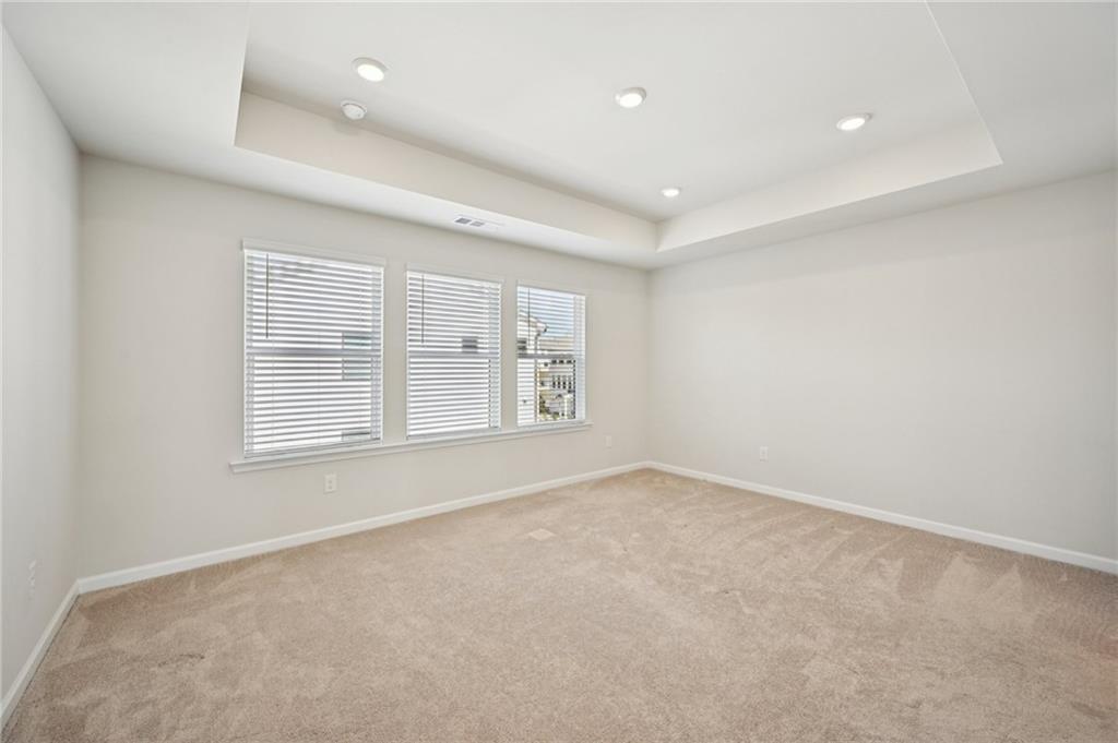 216 Wilder Ridge Way Lawrenceville, GA 30044 - Photo 20 of 46 an empty room with a empty space and windows