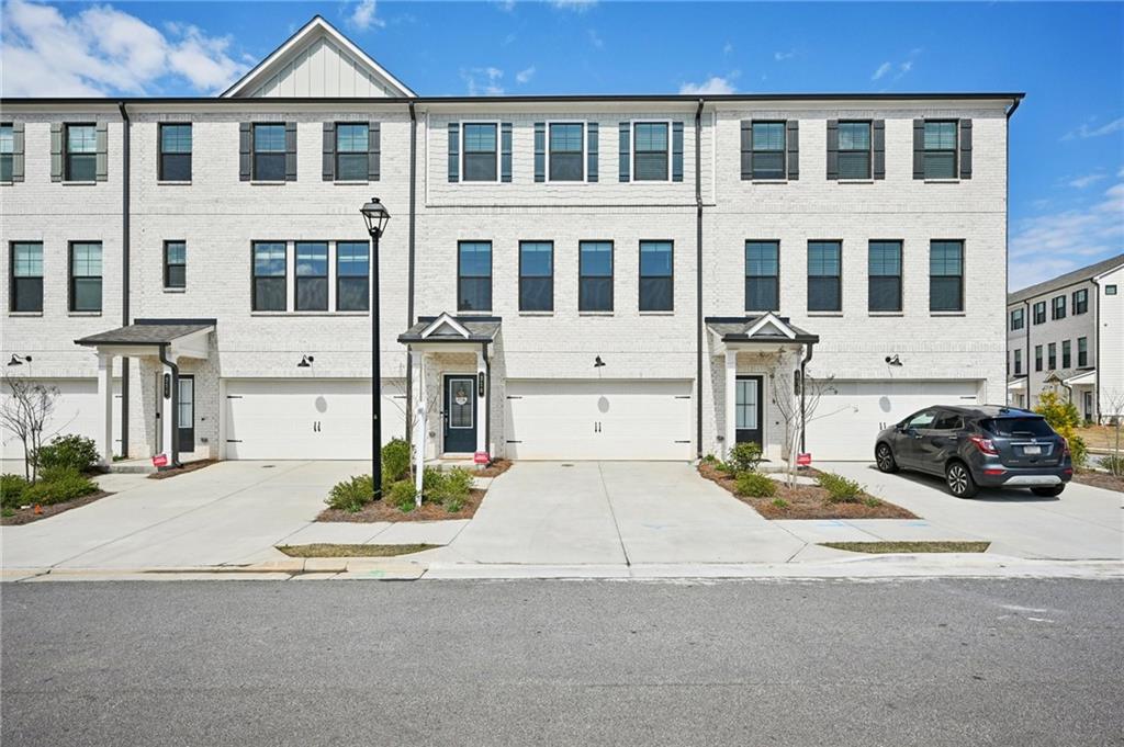 216 Wilder Ridge Way Lawrenceville, GA 30044 - Photo 2 of 46 a view of a car park in front of a building
