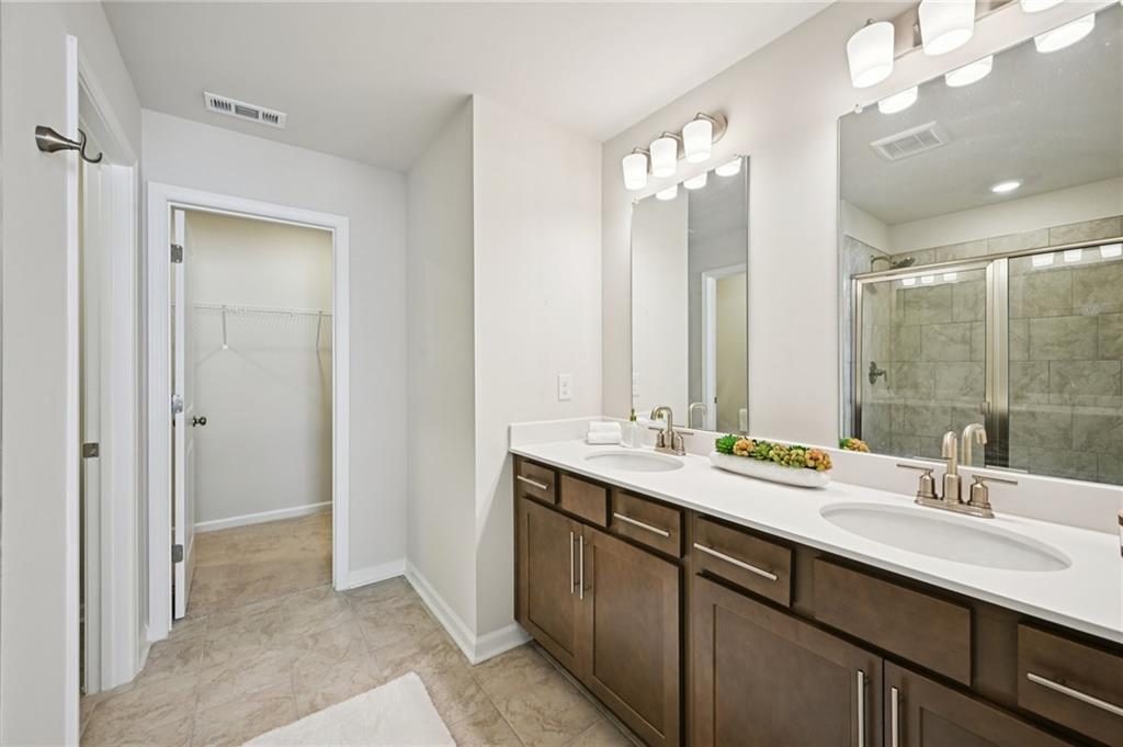 216 Wilder Ridge Way Lawrenceville, GA 30044 - Photo 25 of 46 a bathroom with a double vanity sink mirror and double