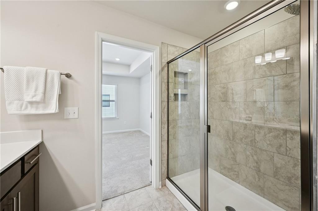 216 Wilder Ridge Way Lawrenceville, GA 30044 - Photo 26 of 46 a bathroom with a shower and a sink