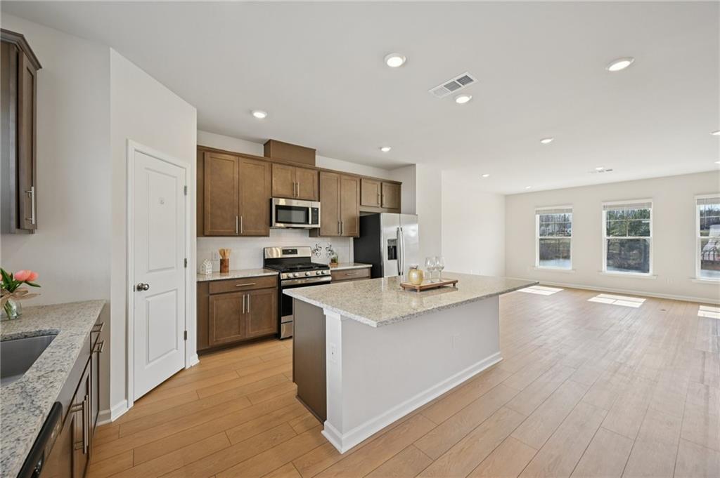 216 Wilder Ridge Way Lawrenceville, GA 30044 - Photo 3 of 46 a kitchen with stainless steel appliances granite countertop a sink stove and refrigerator
