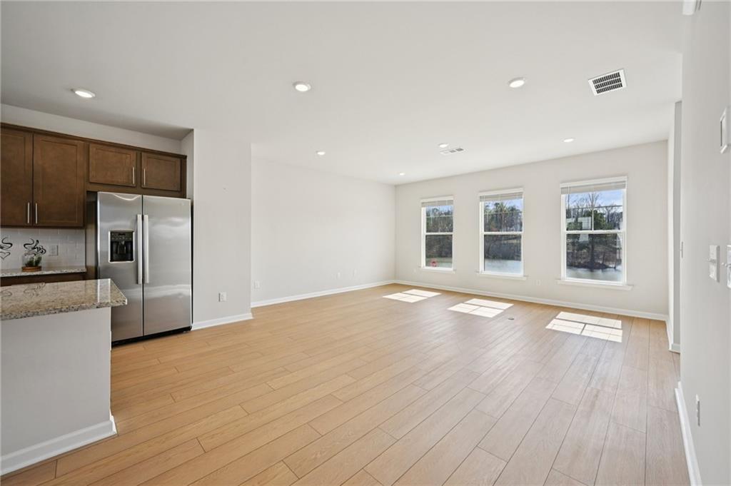 216 Wilder Ridge Way Lawrenceville, GA 30044 - Photo 9 of 46 a view of empty room with wooden floor and electronic appliances