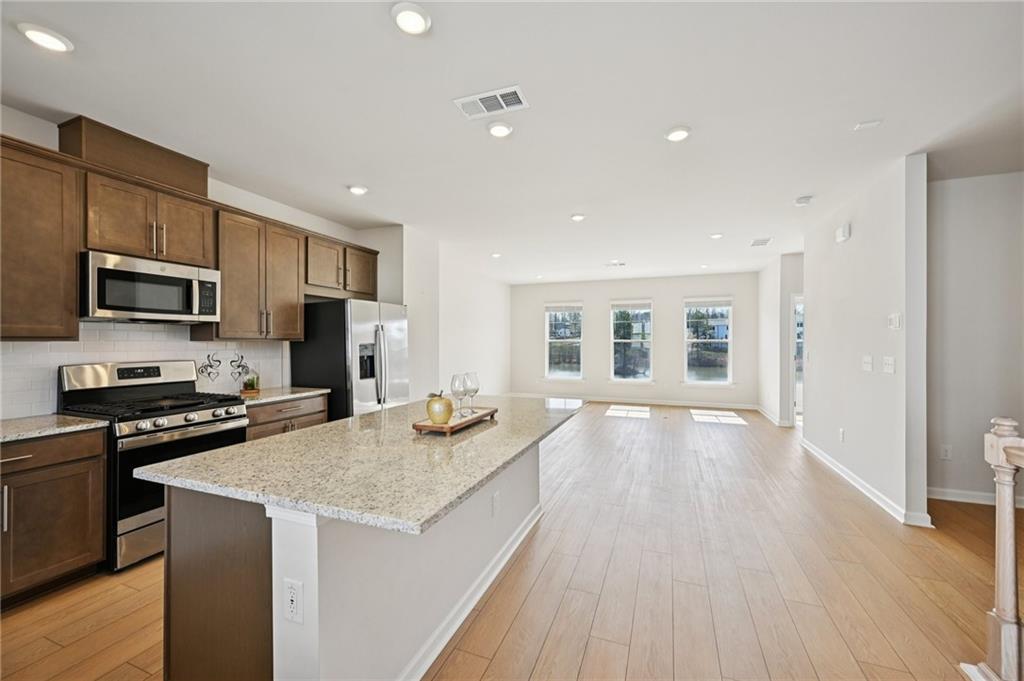 216 Wilder Ridge Way Lawrenceville, GA 30044 - Photo 10 of 46 a kitchen with a sink stove and microwave