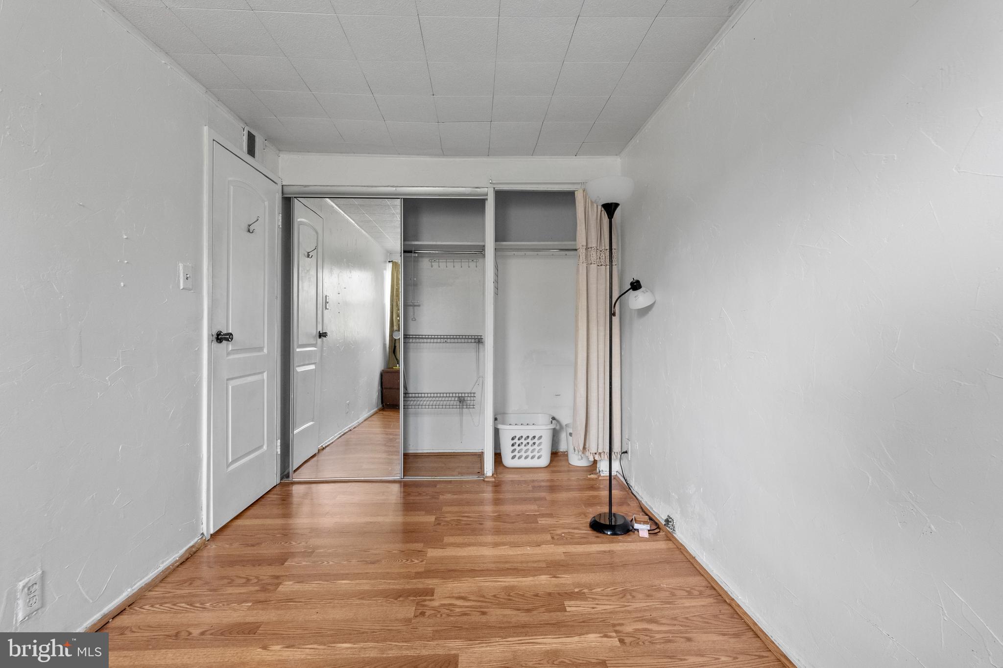 3031 Freeway Halethorpe, MD 21227 - Photo 16 of 25 a view of a hallway with wooden floor and a bathroom
