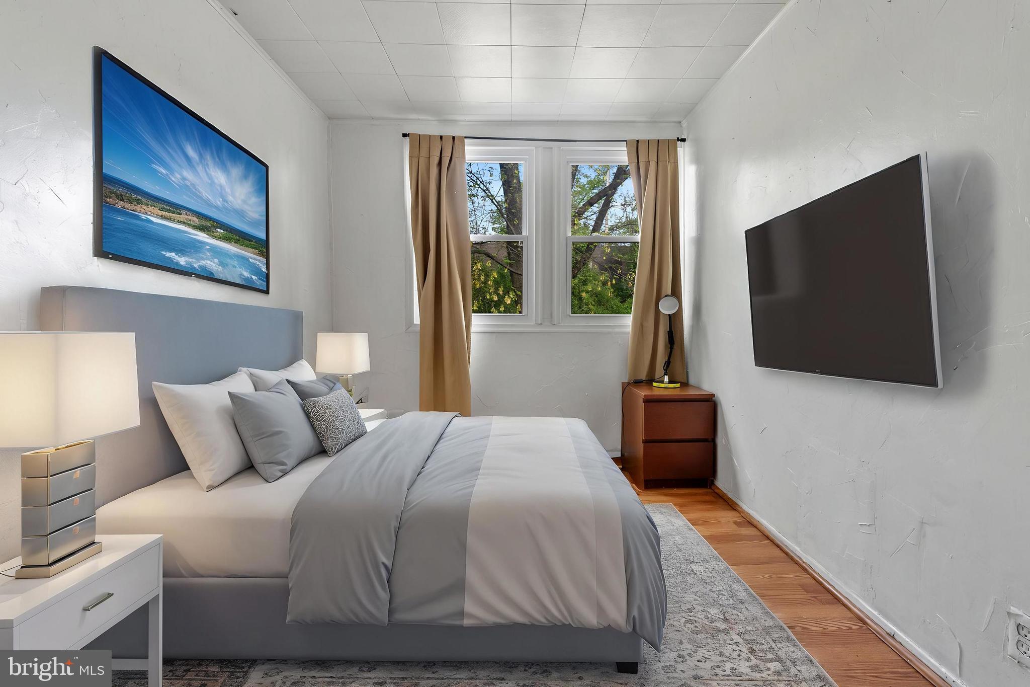 3031 Freeway Halethorpe, MD 21227 - Photo 17 of 25 a bedroom with a bed and a flat screen tv