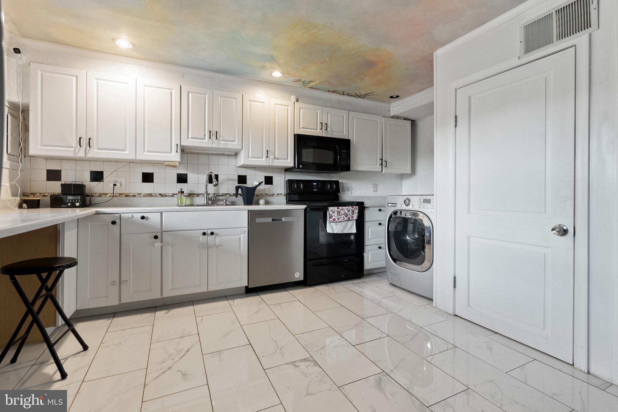 3031 Freeway Halethorpe, MD 21227 - Photo 3 of 25 a kitchen with stainless steel appliances granite countertop a stove a sink and a refrigerator