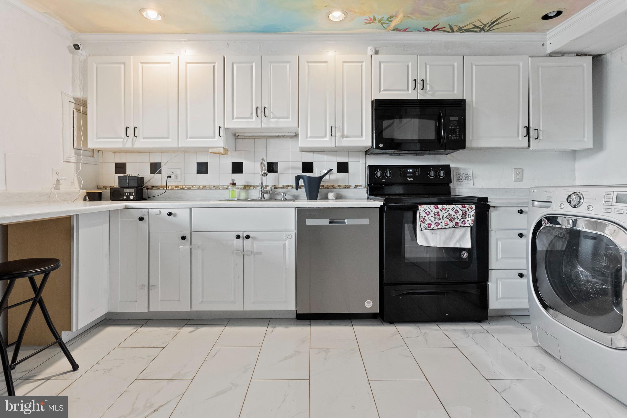 3031 Freeway Halethorpe, MD 21227 - Photo 4 of 25 a kitchen with granite countertop white cabinets and stainless steel appliances