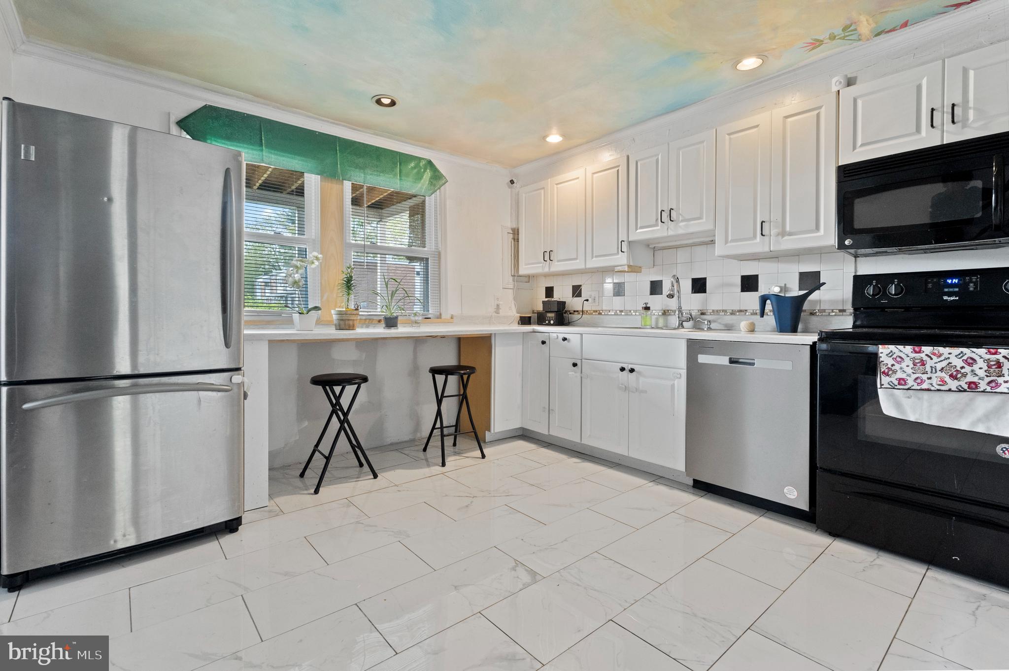 3031 Freeway Halethorpe, MD 21227 - Photo 5 of 25 a kitchen with stainless steel appliances granite countertop a stove a refrigerator a sink and a microwave