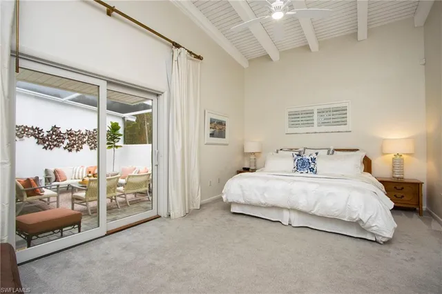 a spacious bedroom with a bed and a couch