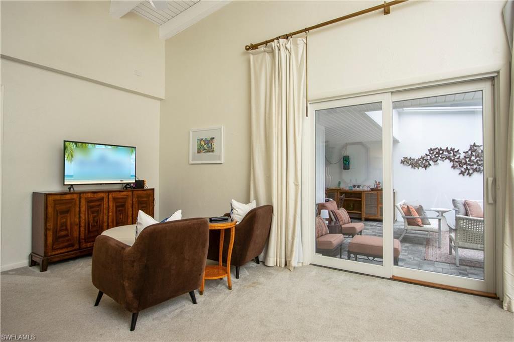 359 2nd Avenue North Naples, FL 34102 - Photo 13 of 41 a living room with furniture and a flat screen tv