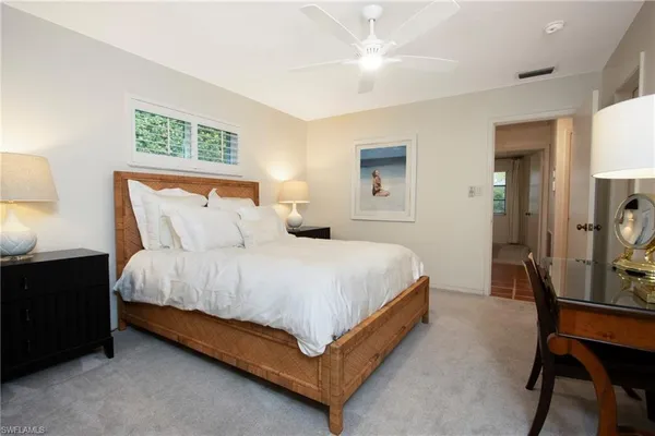 a bedroom with a bed a table and chair