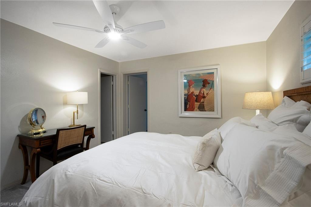 359 2nd Avenue North Naples, FL 34102 - Photo 18 of 41 a bedroom with a bed and wooden floor