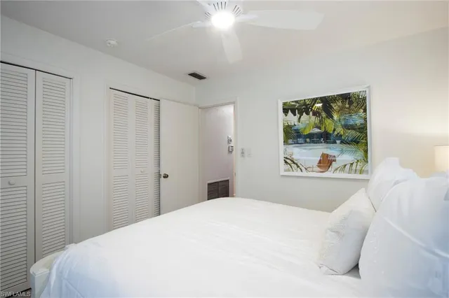 a bedroom with a bed and a painting on the wall