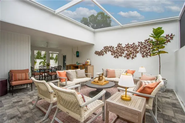 a dining room with furniture and a potted plant