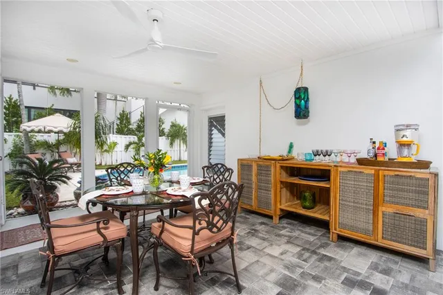 a dining room with furniture and a floor to ceiling window