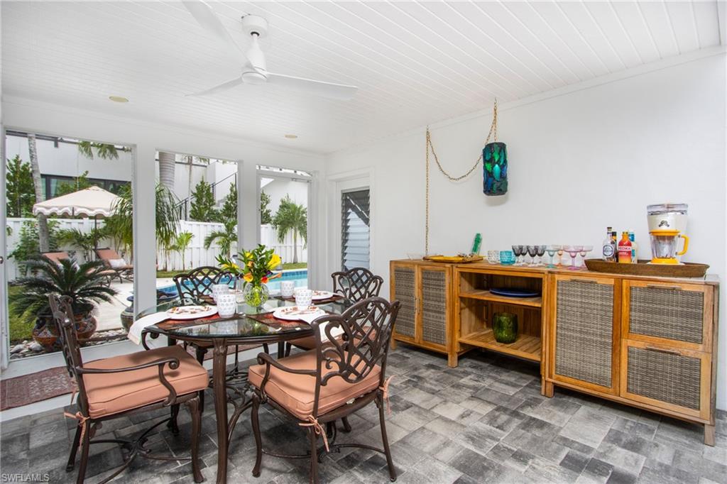 359 2nd Avenue North Naples, FL 34102 - Photo 32 of 41 a dining room with furniture and a floor to ceiling window
