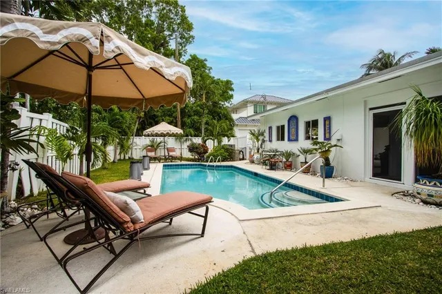 a view of house with swimming pool outdoor seating area and furniture