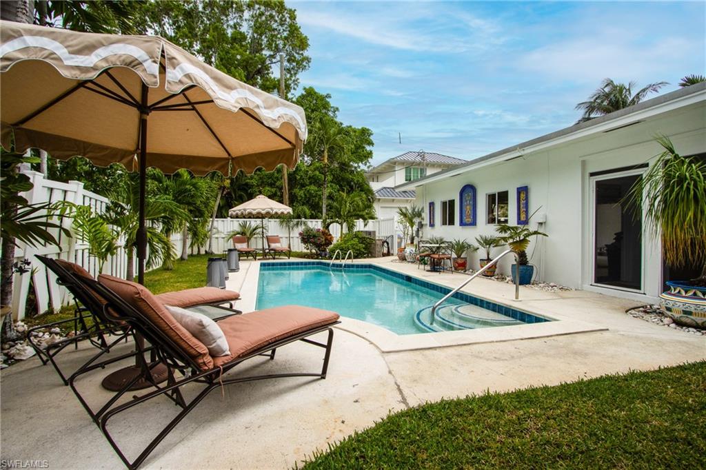 359 2nd Avenue North Naples, FL 34102 - Photo 36 of 41 a view of house with swimming pool outdoor seating area and furniture