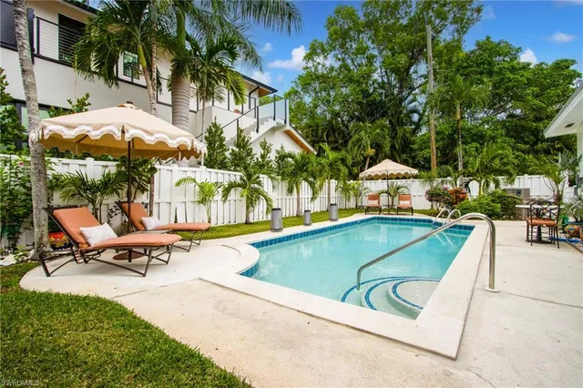 swimming pool with outdoor seating and yard