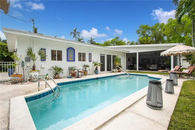 a view of a house with pool table and chairs