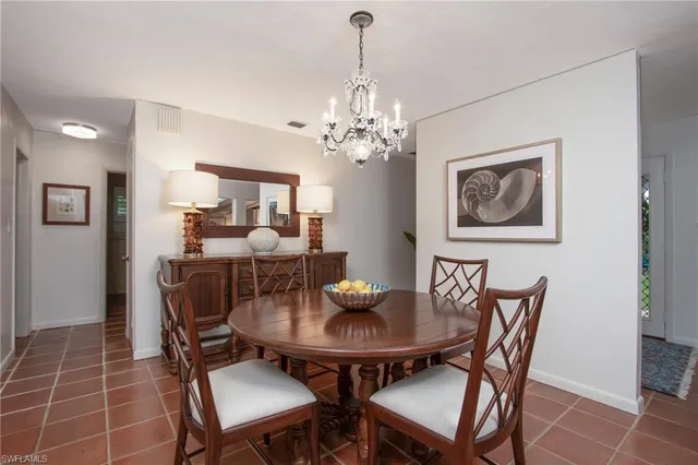 a dining room with furniture and chandelier