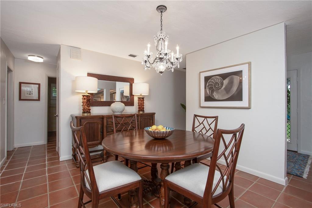 359 2nd Avenue North Naples, FL 34102 - Photo 5 of 41 a dining room with furniture and chandelier