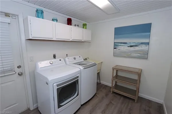 a utility room with sink dryer and washer