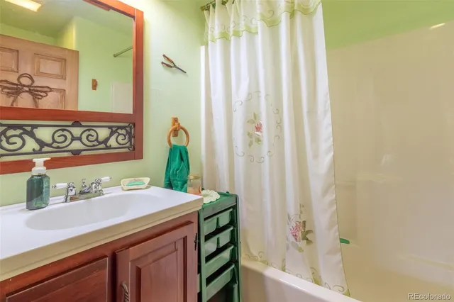 a living room with furniture a flat screen tv and a large window