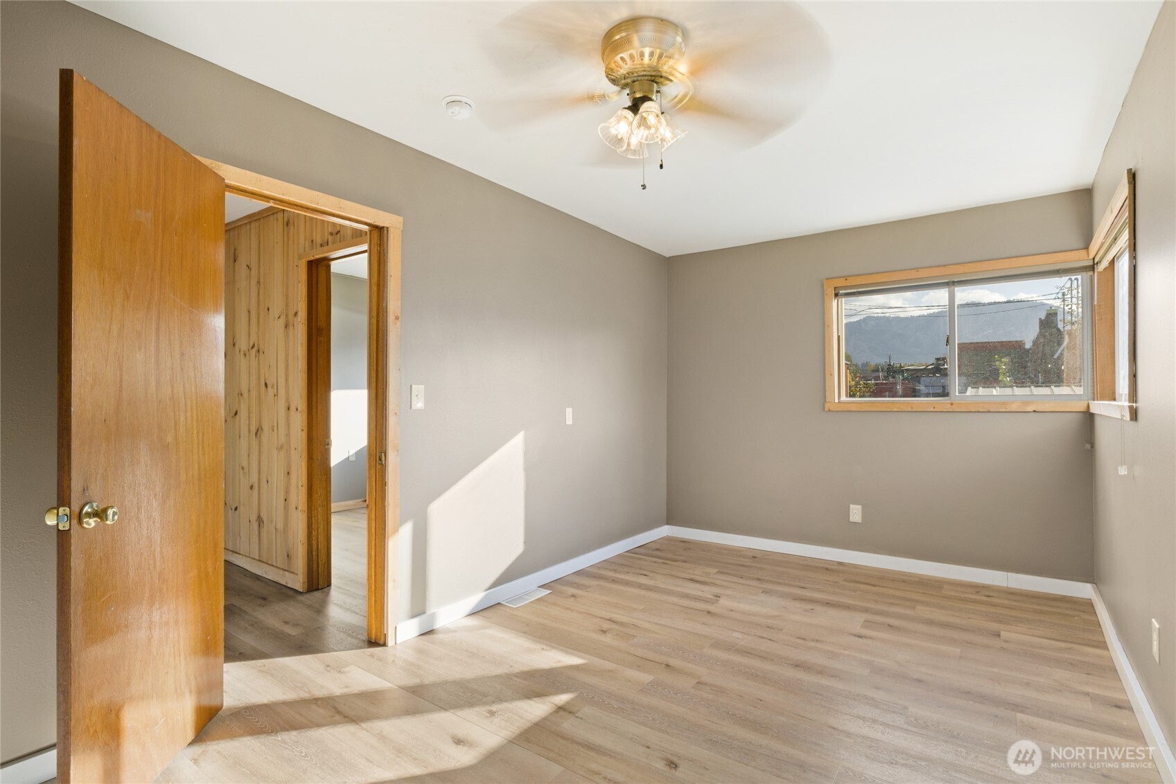 107 West 2nd Street Cle Elum, WA 98922 - Photo 21 of 39 a view of an empty room with wooden floor and a chandelier