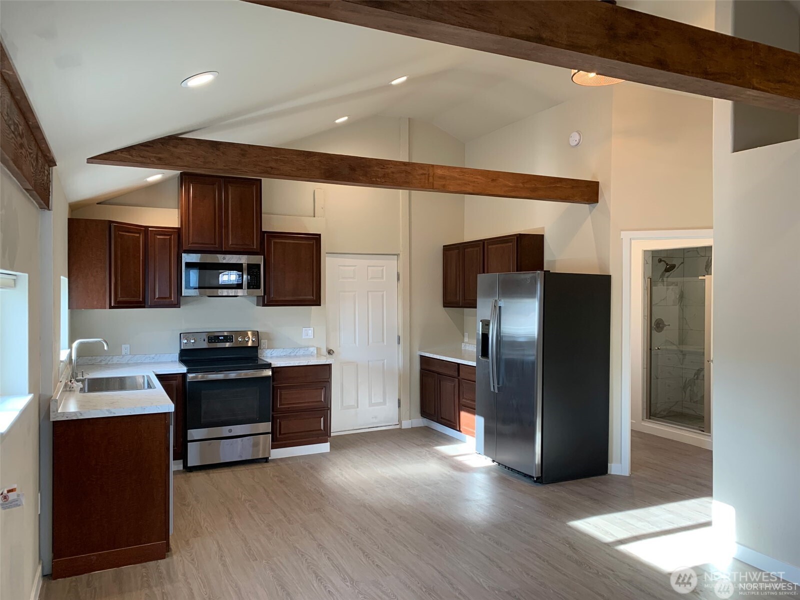 107 West 2nd Street Cle Elum, WA 98922 - Photo 26 of 39 a kitchen with stainless steel appliances kitchen island granite countertop a refrigerator and a stove top oven