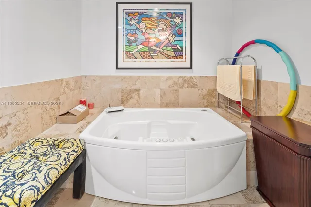 a white bath tub sitting next to a blue wall
