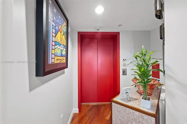 a dining room with furniture and a potted plant