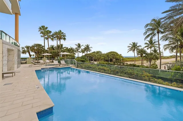 a view of a swimming pool with a patio and garden