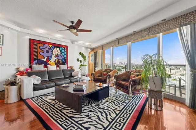 a living room with lots of furniture and a large window