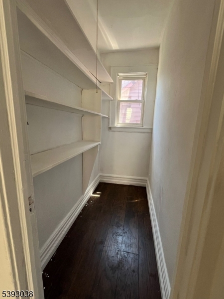 279 Renner Avenue, Unit 2 Newark, NJ 07112 - Photo 11 of 12 an empty room with wooden floor and windows
