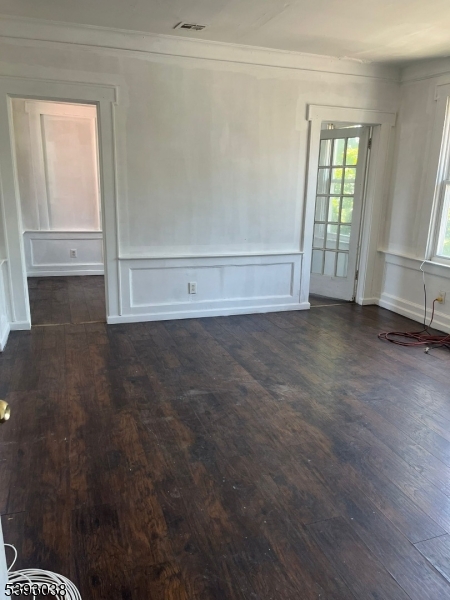 279 Renner Avenue, Unit 2 Newark, NJ 07112 - Photo 2 of 12 a view of an empty room with wooden floor and a window