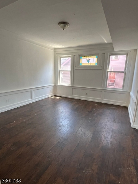 279 Renner Avenue, Unit 2 Newark, NJ 07112 - Photo 3 of 12 an empty room with wooden floor and windows