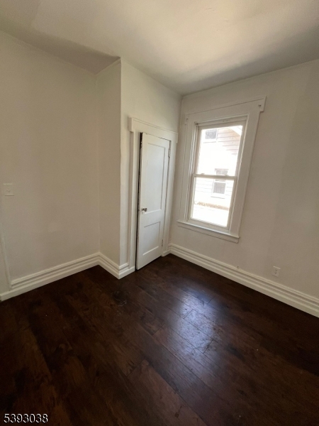 279 Renner Avenue, Unit 2 Newark, NJ 07112 - Photo 8 of 12 a view of an empty room with wooden floor and a window