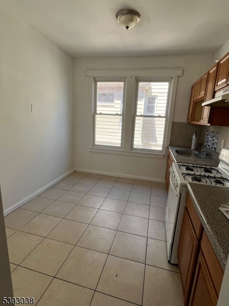 279 Renner Avenue, Unit 2 Newark, NJ 07112 - Photo 10 of 12 a view of a kitchen with a sink a stove top oven and cabinets