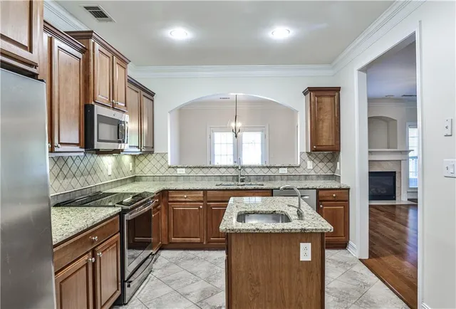 a kitchen with a stove sink and cabinets