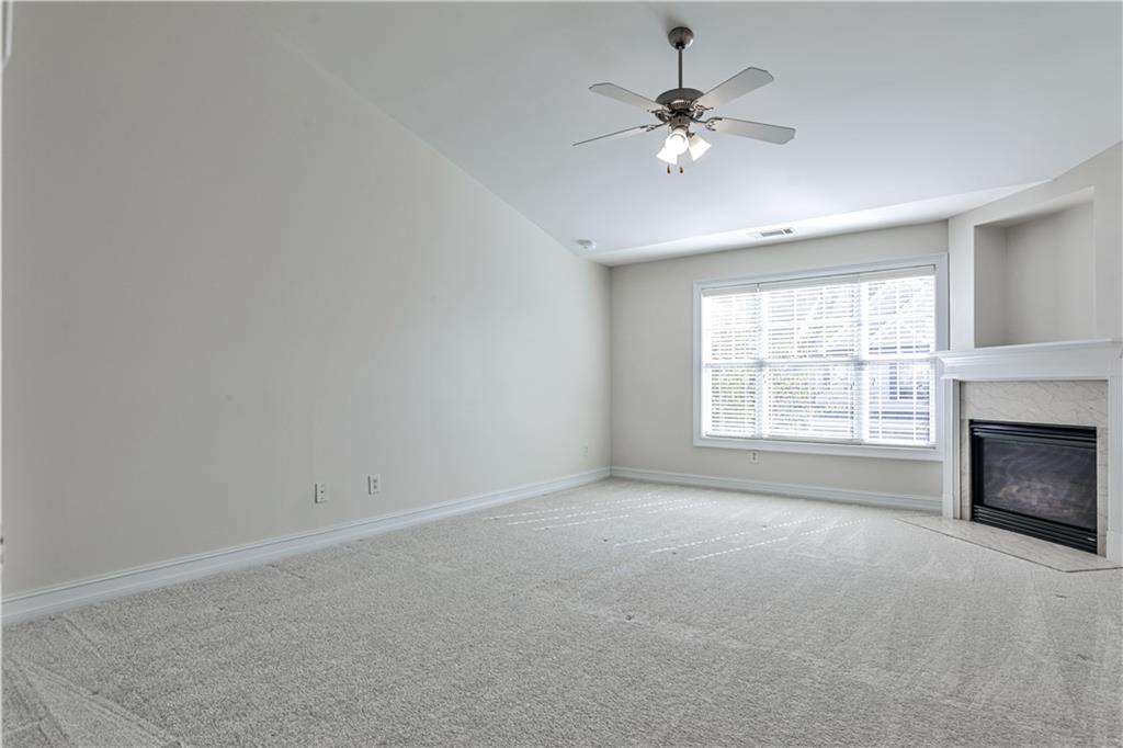 7 Reese Way Avondale Estates, GA 30002 - Photo 13 of 28 an empty room with fireplace and windows