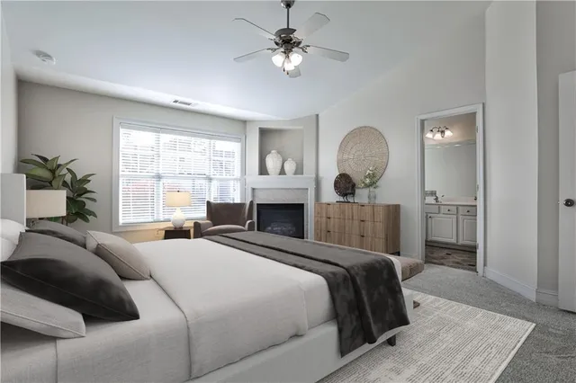 an empty room with windows and a fireplace