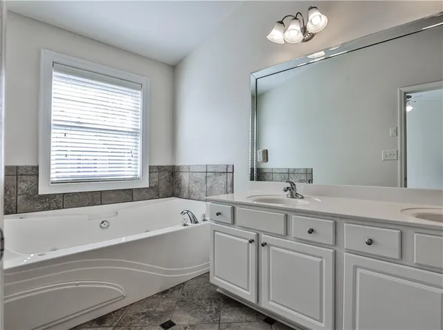 a bathroom with a sink a mirror and a shower