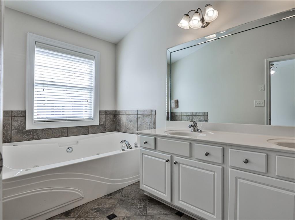 7 Reese Way Avondale Estates, GA 30002 - Photo 16 of 28 a bathroom with a bathtub a sink and a window